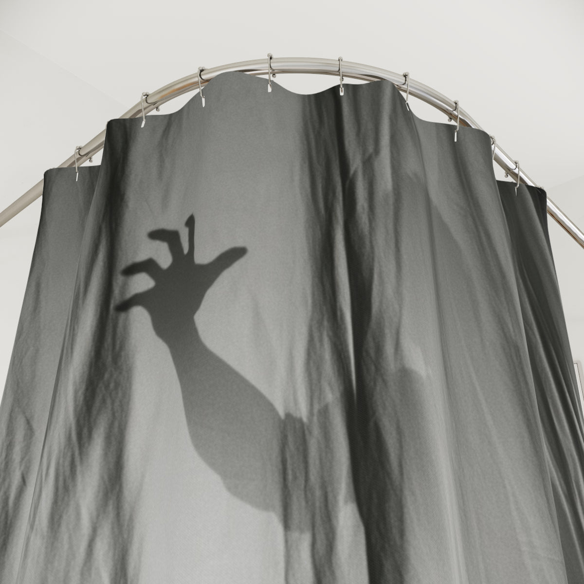 Dark gray shower curtain close-up of spooky hand silhouette over rippled fabric