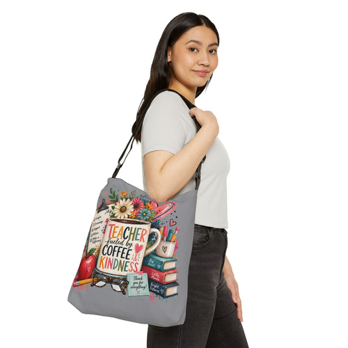 Gray tote bag worn on shoulder with Teacher-themed print and adjustable straps.