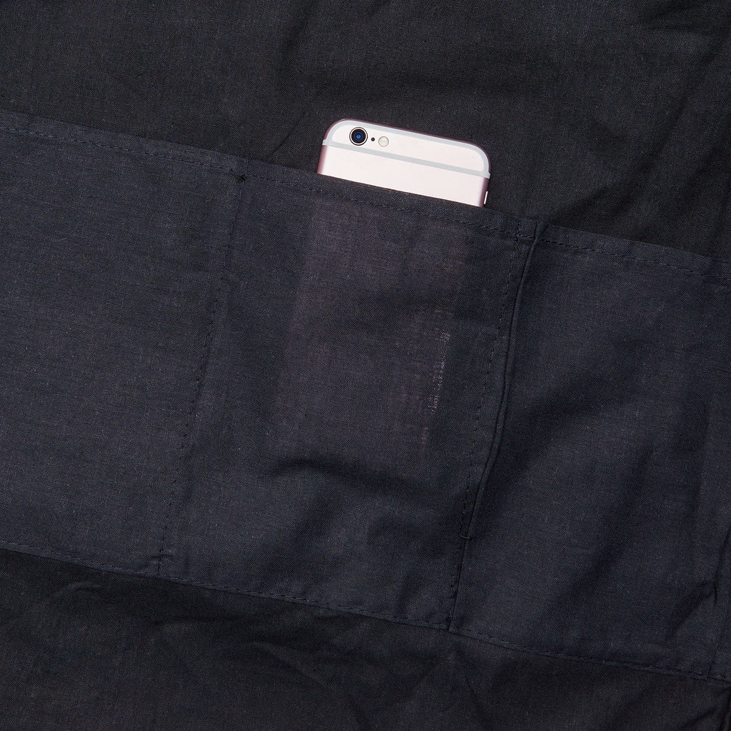 Dark interior pocket holding a smartphone inside the tote bag.